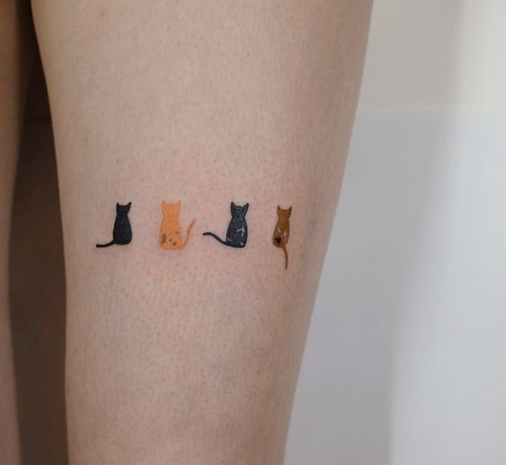 minimalist small cat tattoo