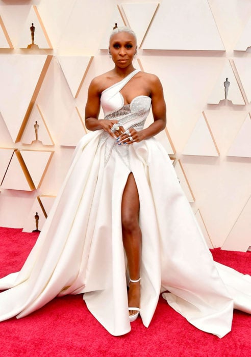 Cynthia Erivo con un vestido blanco y aplicaciones en plateado durante la alfombra roja de los premios Oscar 2020