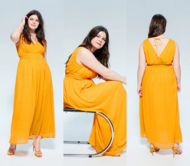 chica curvy con cabello castaño largo, usando un vestido largo amarillo y tacones nude