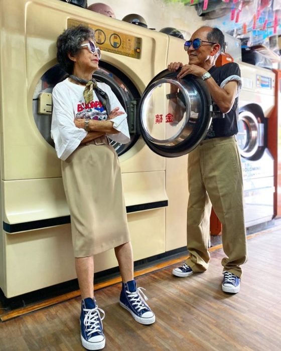 Pareja de abuelitos llevando conjuntos a juego en color beige dentro de una lavandería