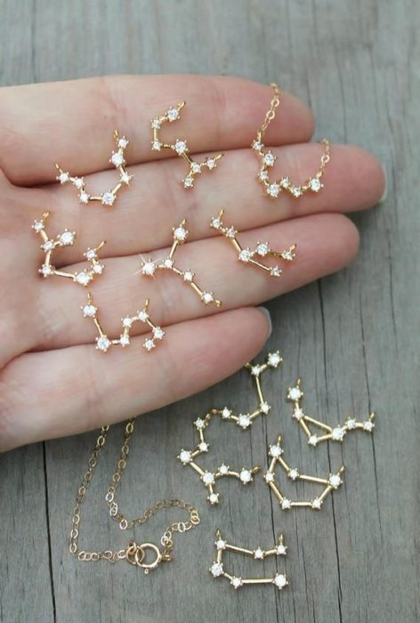 Aretes inspirados en el universo en color dorado con constelaciones