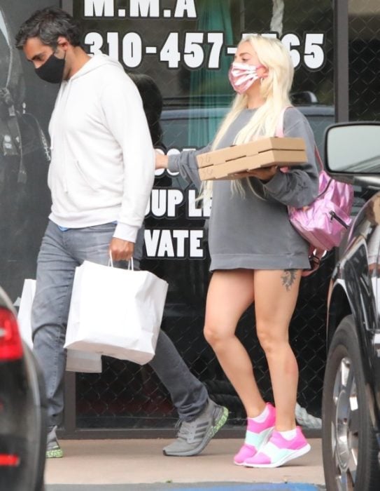 Lady Gaga caminando en la calle con una sudadera gris