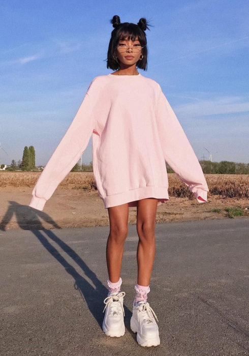 Looks con sudadera; chica morena con cabello negro, corto, con peinado de chongos de Sailor Moon, hoodie rosa pastel oversized como vestido, con tenis blancos de plataforma