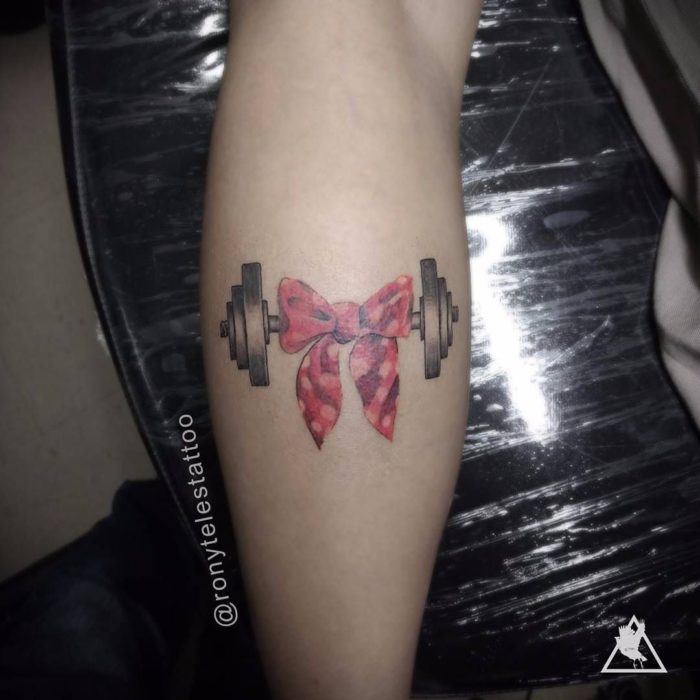 Chica con un tatuaje en el brazo de unas pezas 