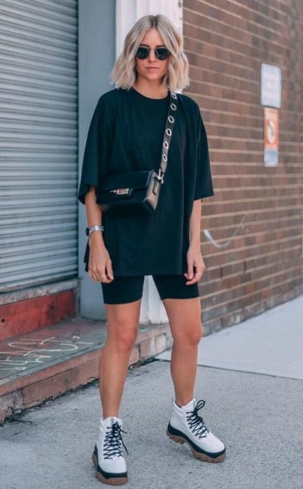 chica rubia con melena con blusa y shorts de ciclista color negros 