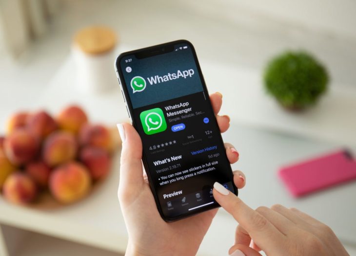 Persona con el celular en la mano en la aplicación de WhatsApp