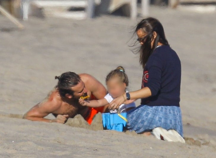Bradley Cooper y a Jennifer Garden en la playa