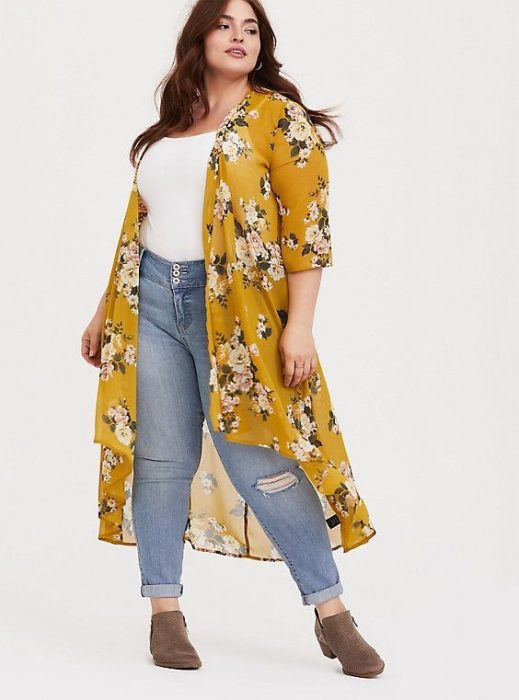 Chica usando outfit veraniego de jeans denim, top blanco, ensamble amarillo con estampado de flores y botines