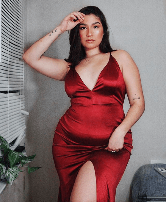 chica de cabello castaño largo usando un vestido ceñido curvy color rojo con escote en V y apertura en la pierna