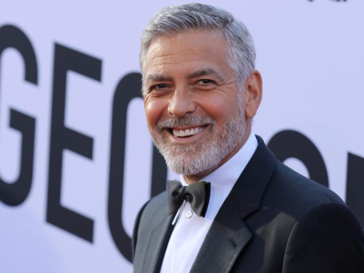 George Clooney en una alfombra roja sonriendo