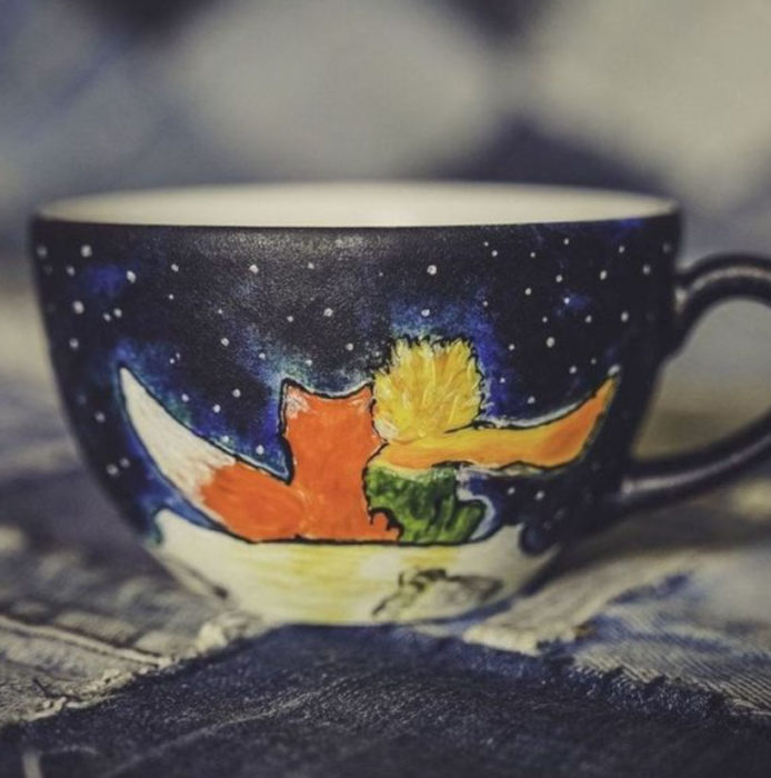 Taza inspirada en El Principito, donde se ve una noche estrellada y al Principito y al zorro viendo las estrellas