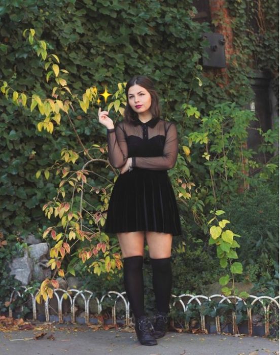 chica posando con vestido y botas negras