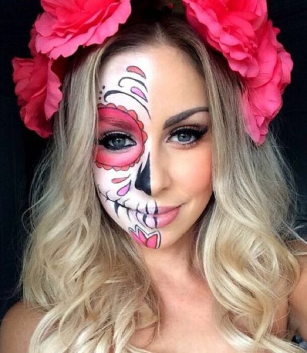 Chica con un maquillaje de catrina en colores blancos con rosa 