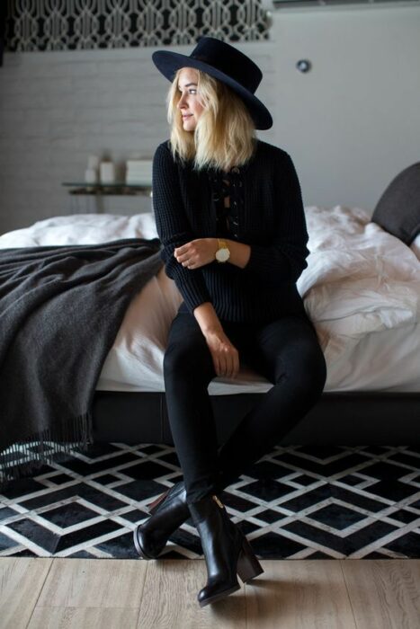 Chica usando sombrero de color negro con outfit de total black look 