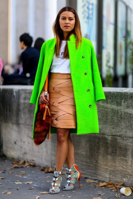 Chica usando un outfit en colores neón con café y blanco 