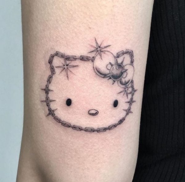 Tatuaje de Kitty con púas metálicas alrededor