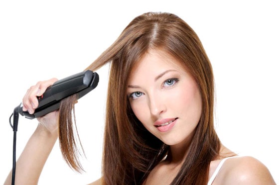Chica planchando su cabello 