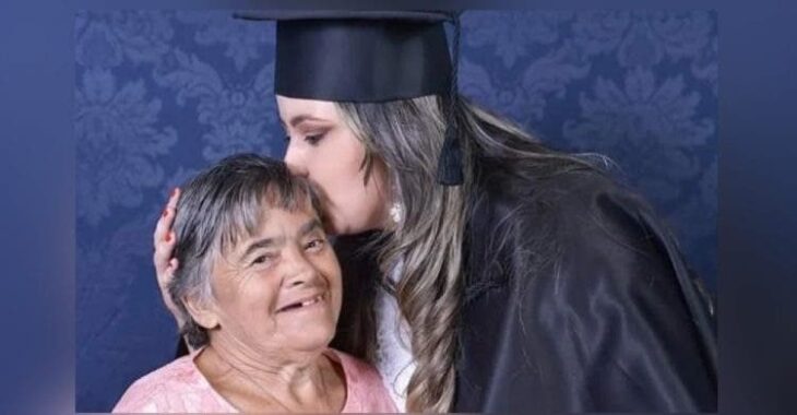 Chica durante su graduación besando a su mamá en la frente; Festeja la graduación con su madre afectada con Síndrome de Down