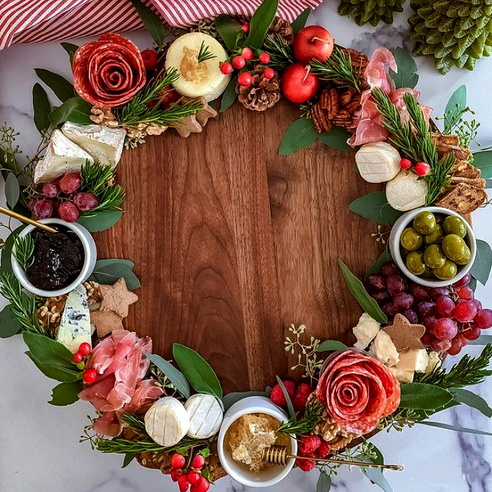 tabla de quesos, embutidos, charcutería, uvas, salami, jamón serrano, con estilo navideño