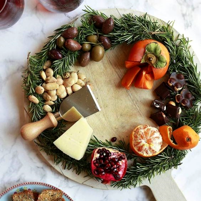 tabla de quesos, embutidos, charcutería, uvas, salami, jamón serrano, con estilo navideño