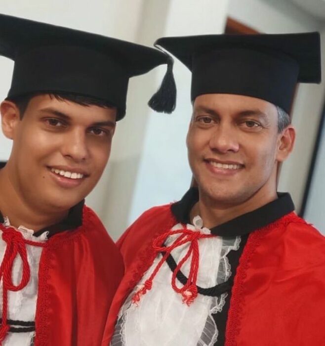 Padre e hijo llevando sus togas de graduación; Padre ingresa a estudiar para apoyar a su hijo con Asperger