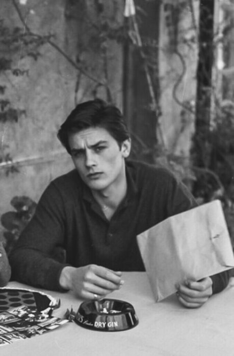 Alain Delon sentado en un sofá