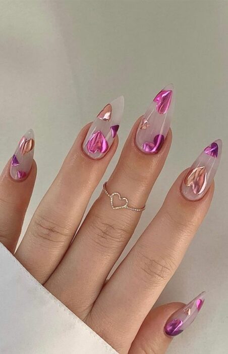 Uñas transparentes con corazones brillantes color rosa