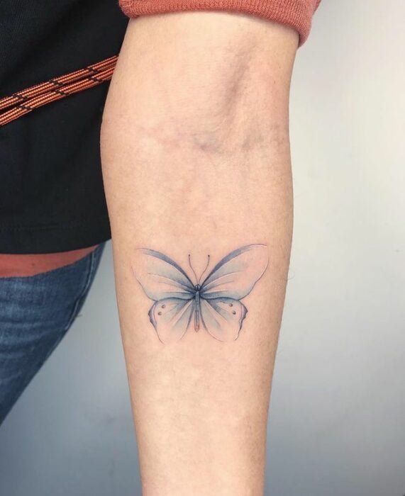 Tatuaje de mariposa en color azul con silueta degradada;  15 Bellos tatuajes con mariposas para iniciar una metamorfosis