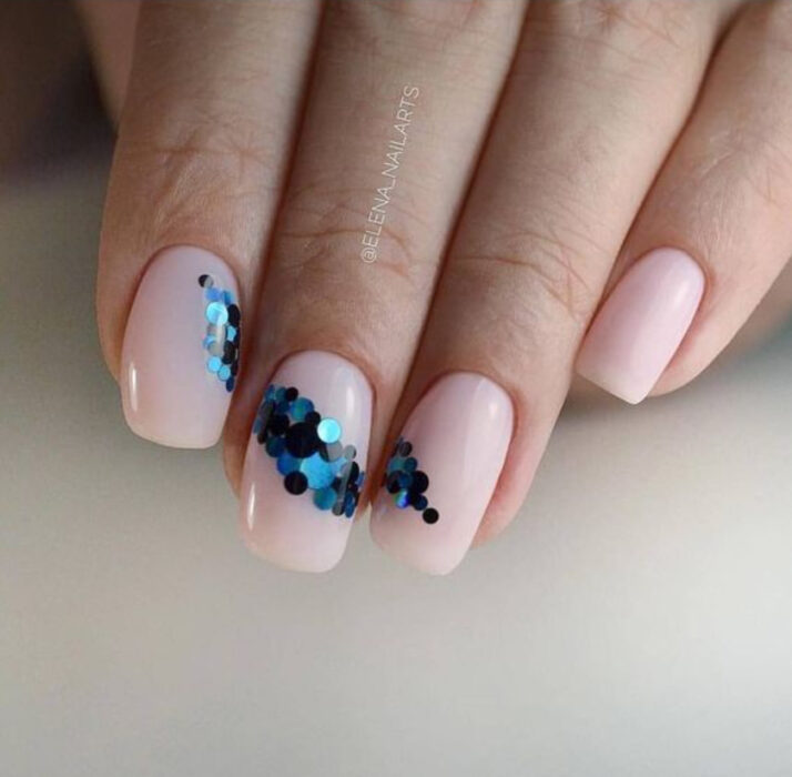 Manicura con fondo nude con detalles de glitter en color azul rey