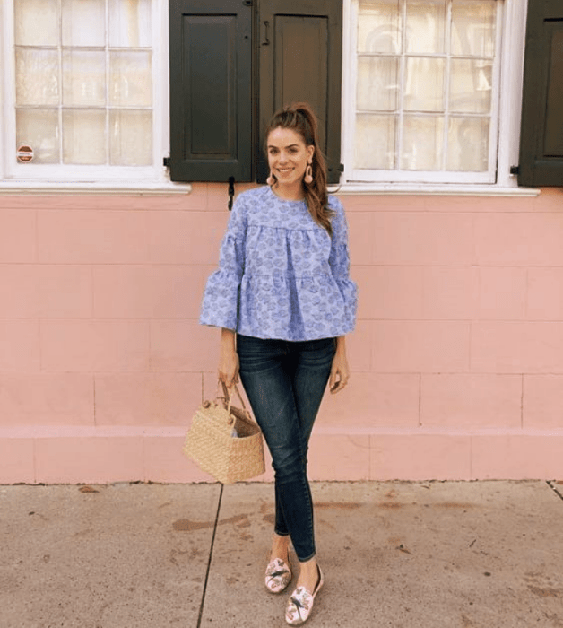 chica de cabello castaño usando una blusa azul celeste holgada, skinny jeans, flats rosas con café