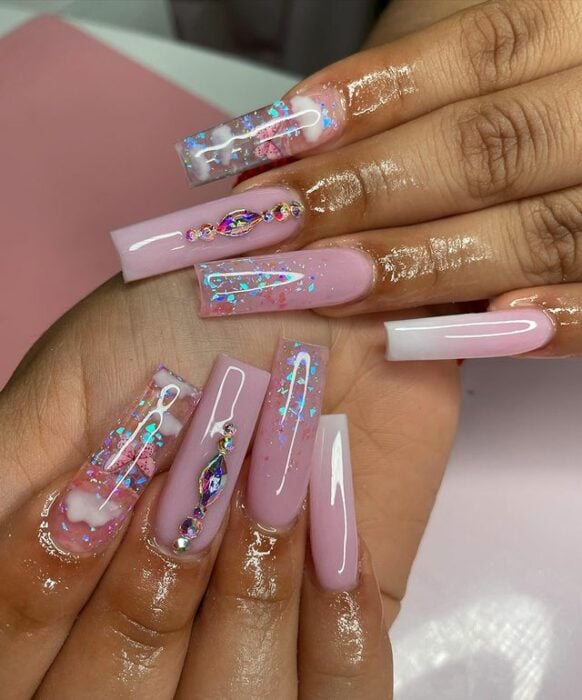 Chica con unas uñas extra largas con diseño en color rosa