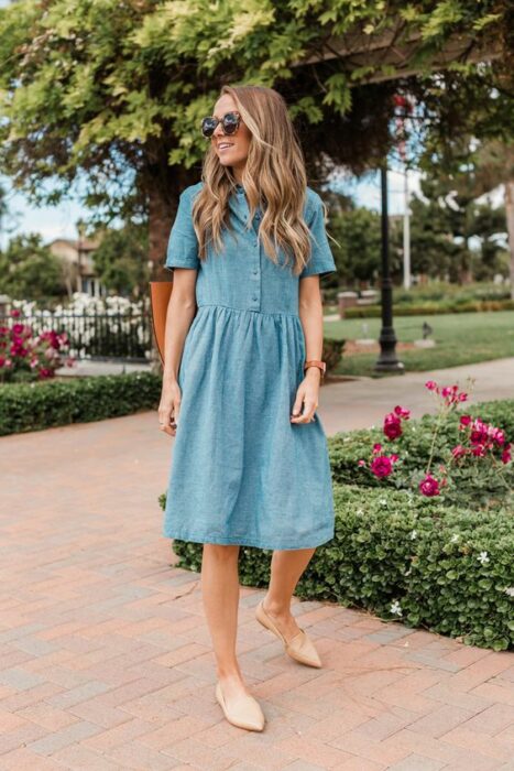 Chica usando un vestido de mezclilla con flats 