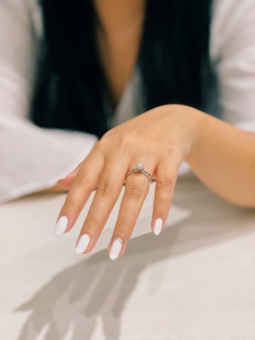 Girl showing her engagement ring;  The more expensive the engagement ring the faster the divorce will come study