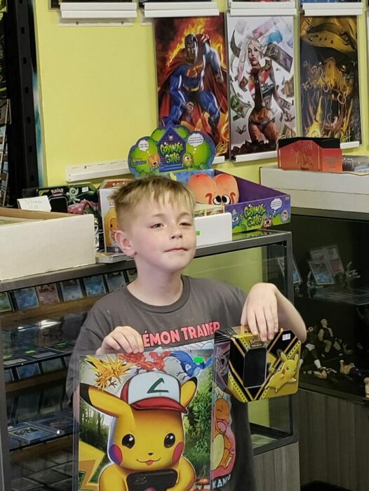 Niño sosteniendo sus juguetes de Pokémon