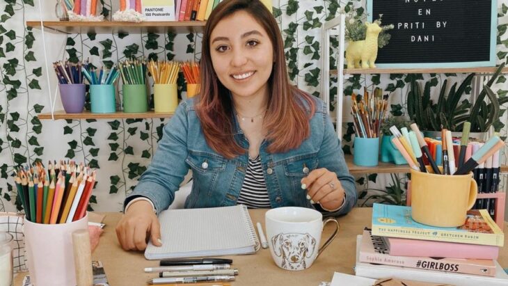 Girl sitting at her desk; This youtuber went viral for buying the house of her dreams