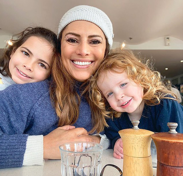 Sally Obermeder posing with her belly while her daughter is watching