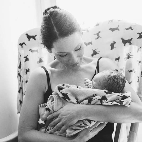 Lucy Liu holding her newborn son in her arms 