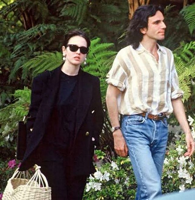 Daniel Day-Lewis and Isabelle Adjani holding hands and walking down the street 