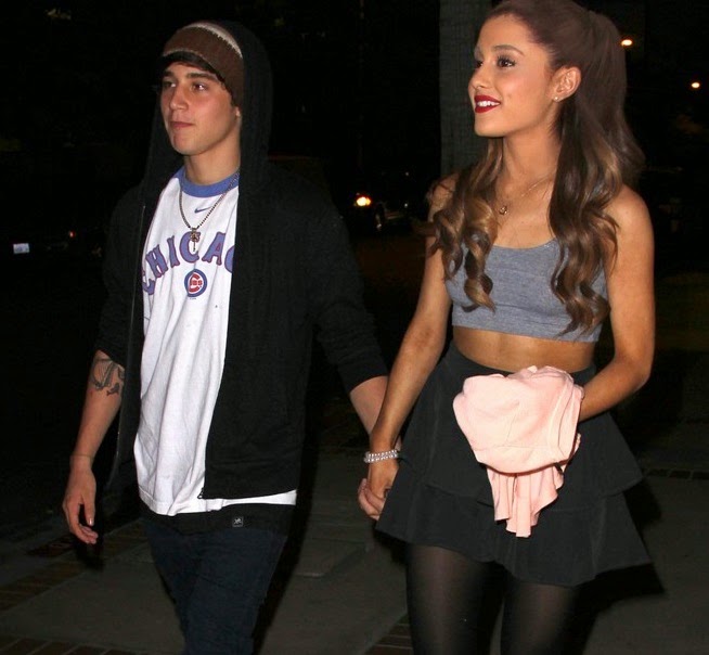 Ariana Grande and Jai Brooks holding hands and walking down the street 