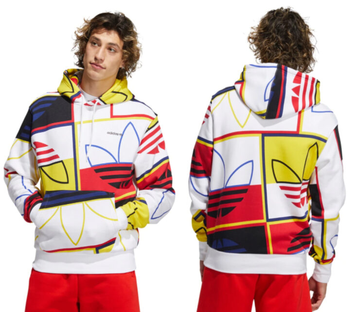 Boy modeling an adidas Forum sweatshirt, white with yellow and red colors