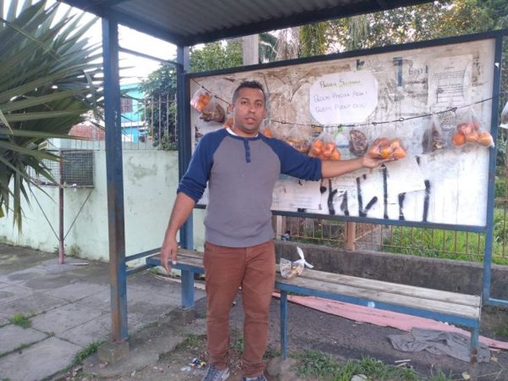 Boy in front of a bus stop;  Neighbors leave fruit and bread at a bus stop for those most in need