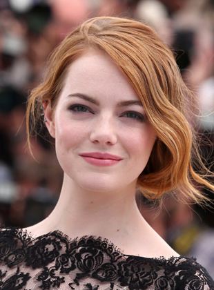 Emma Stone posando para una fotografía en una alfombra roja 