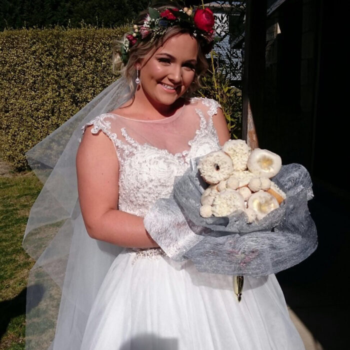 Mujer usando un ramo de novia hecho de donas 