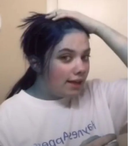 Chica mostrando su cuerpo y cabello teñido de color azul