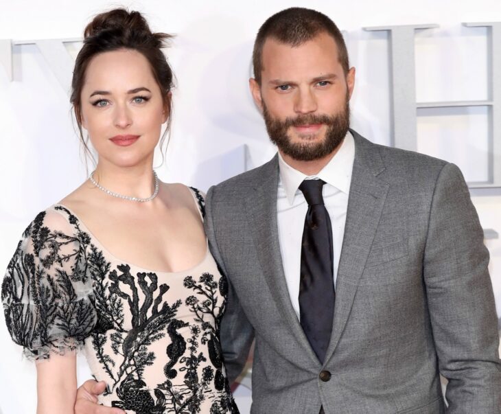 Jamie dornan and dakota johnson posing for a picture 