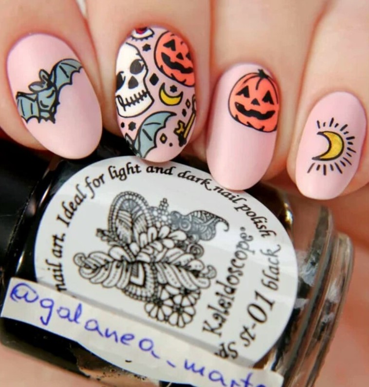 Manicure with a pink background and skulls;  18 Manicures Your Inner Witch Won't Resist