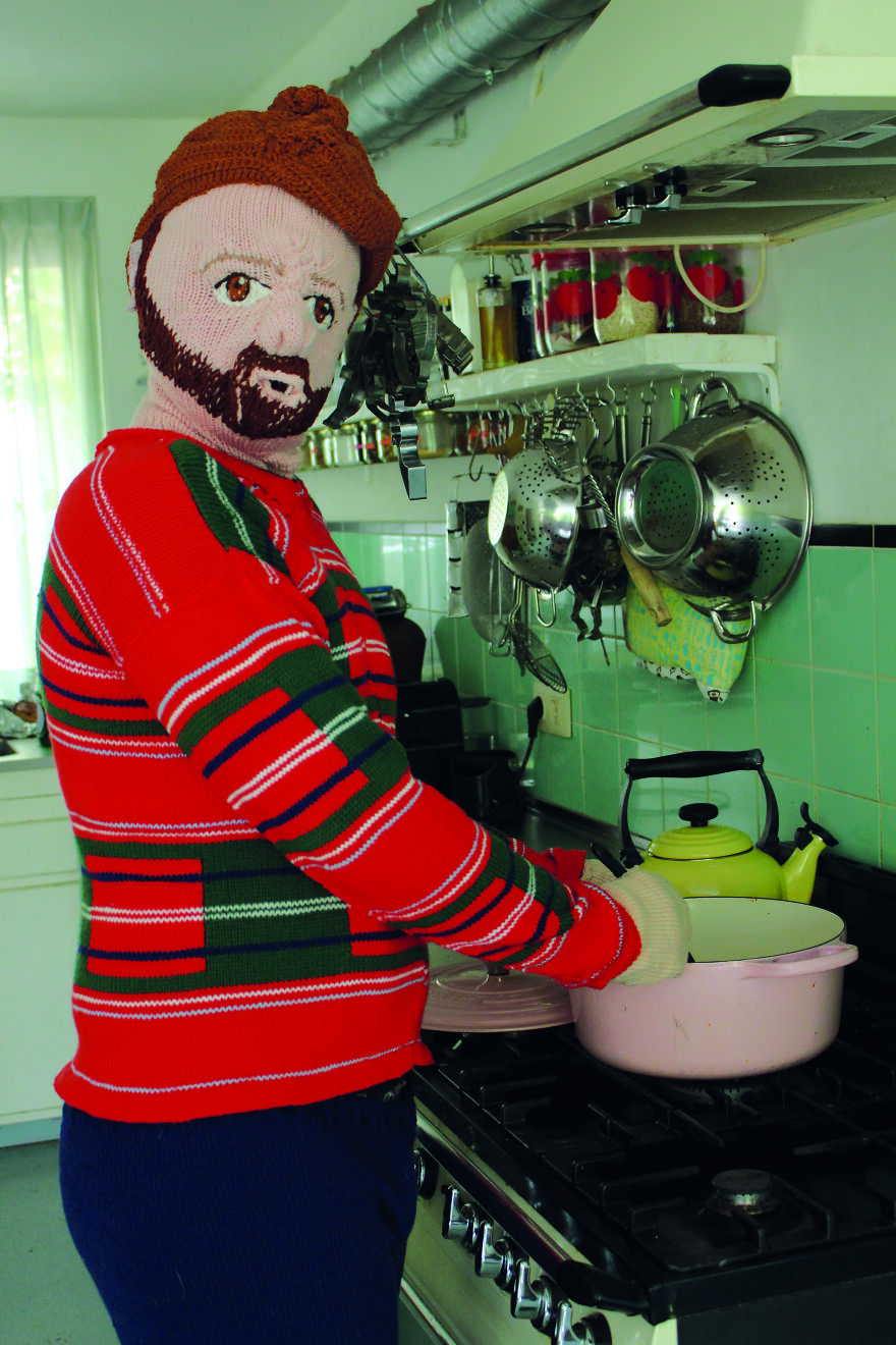 Woven doll inside the kitchen;  Woman weaves her husband and son in life size