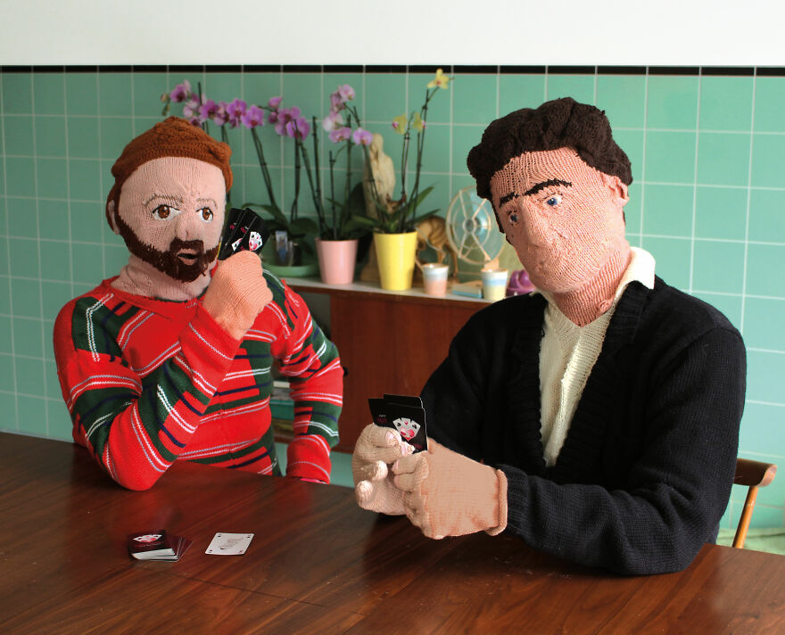 Knitted dolls playing cards;  Woman weaves her husband and son in life size