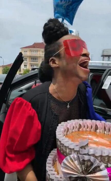 Boy receiving a cake with tickets on his birthday 