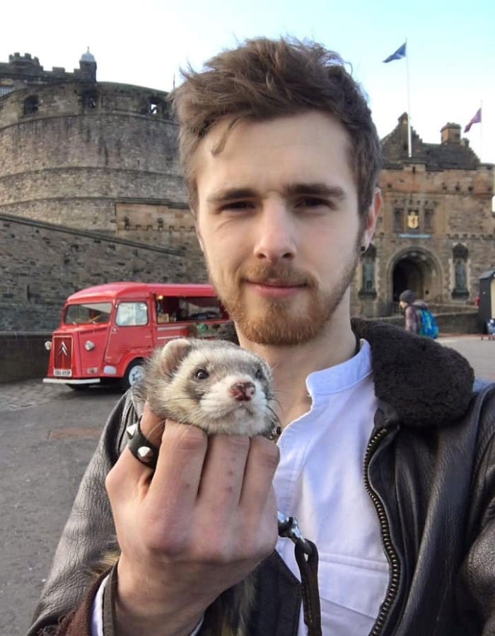 boy carrying a ferret;  20 cute pictures that will make you want to have a ferret